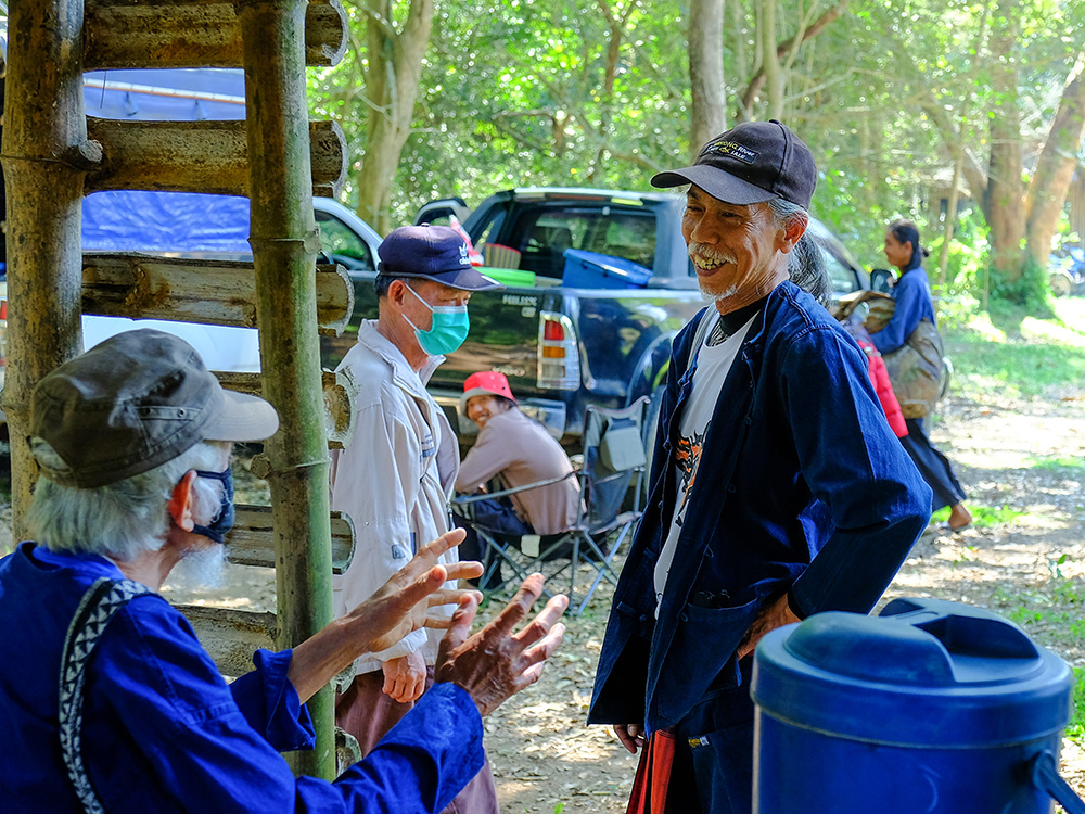 Goldman Prize winner Niwat Roykaew speaks to community members in Thailand with a smile on his face.
